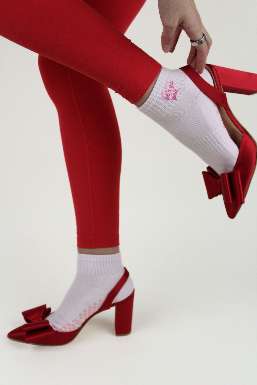 PREORDER: Let's Go Girls Grip Socks worn with red leggings and red heeled shoes featuring bows on a white background